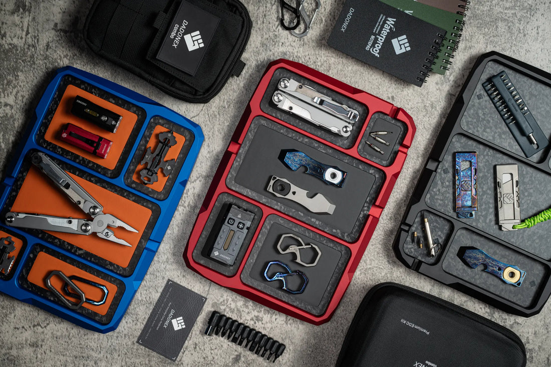 Blue, red and black VERTEX Dock trays arranged with optional pads and everyday carry tools