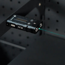 OMNI Beacon projecting a green laser from a metal shelf