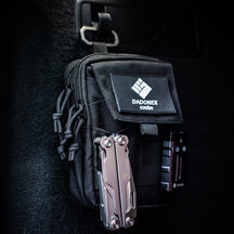 OMNI Cache pouch worn on clothing with a multi tool and light attached