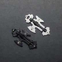 Silver and black OMNI Scout multi tools on a dark surface