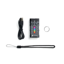 OMNI Beacon with USB charging cable, wrist strap and keyring on a white background