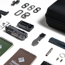 Close-up of the OMNI Field tools, carabiners, light and writing accessories