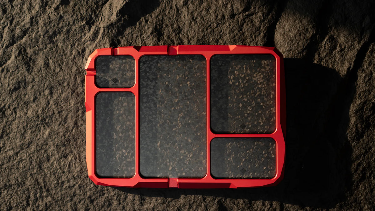 Apex Red VERTEX Dock tray with optional carbon-fiber pad set, top view on dark stone