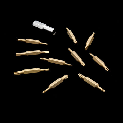 Gold VERTEX Prism double-ended bits and adapter arranged on a black background